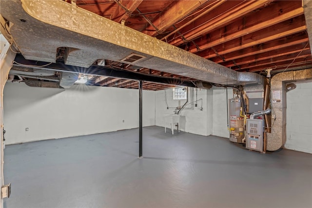 basement featuring heating unit and gas water heater