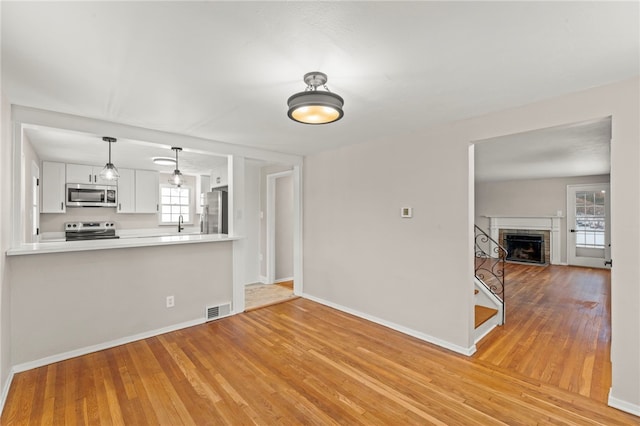 interior space featuring a fireplace and light hardwood / wood-style flooring