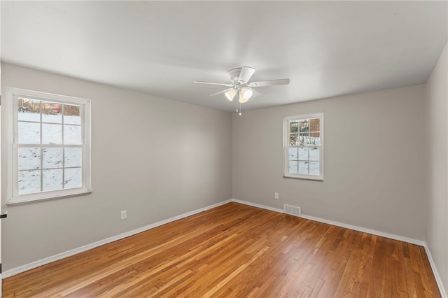 spare room featuring ceiling fan and hardwood / wood-style floors