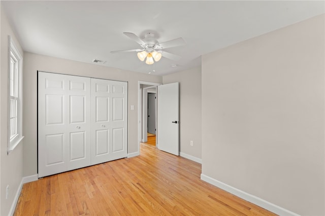 unfurnished bedroom featuring a closet, ceiling fan, and light wood-type flooring