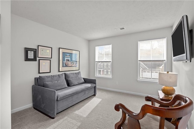 carpeted living room featuring a textured ceiling