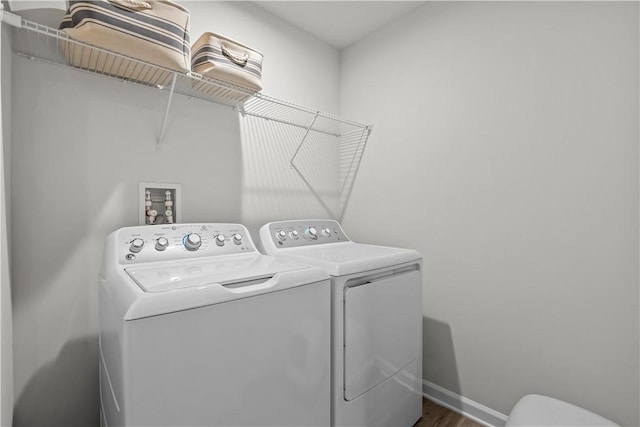 laundry room featuring dark wood-type flooring and washing machine and clothes dryer