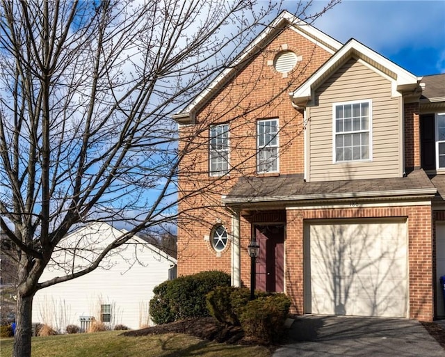 view of property with a garage and a front lawn