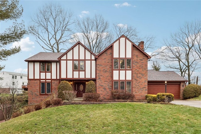 tudor home with a garage and a front lawn