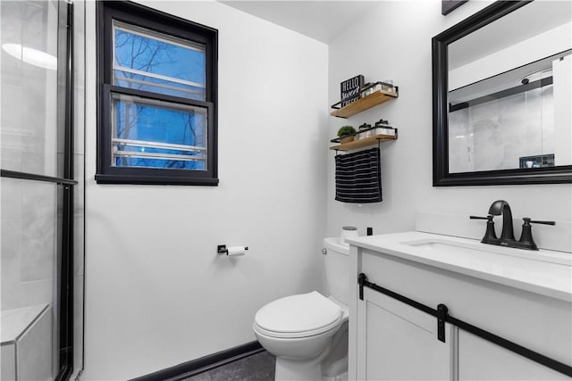 bathroom with walk in shower, vanity, and toilet