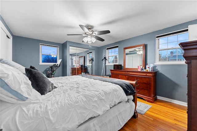 bedroom featuring wood-type flooring, a closet, and ceiling fan