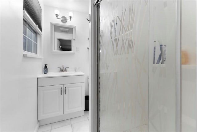 bathroom with vanity and a shower with door