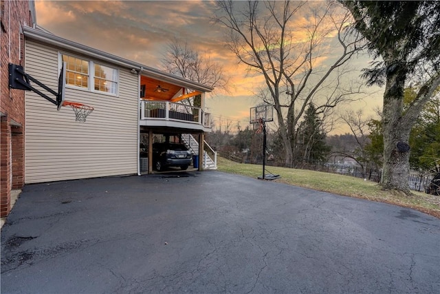 property exterior at dusk featuring ceiling fan