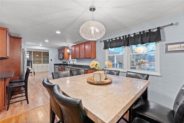 dining room with sink and light hardwood / wood-style flooring