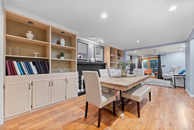 dining area with ornamental molding, ceiling fan, and light wood-type flooring