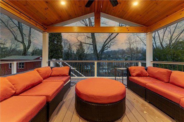 deck at dusk with ceiling fan and outdoor lounge area