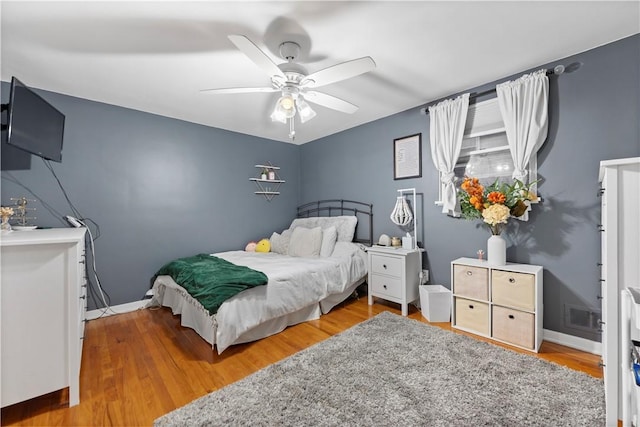 bedroom with hardwood / wood-style floors and ceiling fan