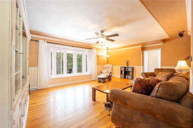 living room with ornamental molding, ceiling fan, and light hardwood / wood-style floors