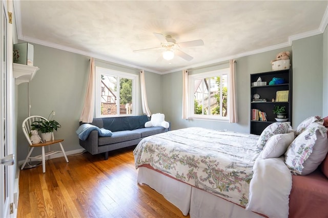 bedroom with multiple windows, ornamental molding, and light hardwood / wood-style floors