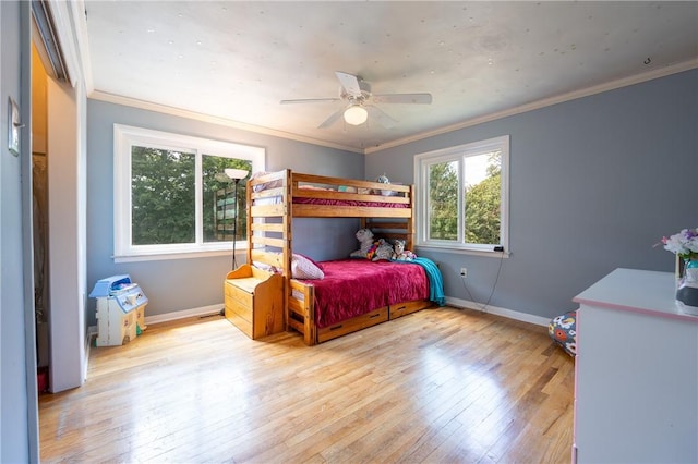 bedroom featuring crown molding, ceiling fan, and light wood-type flooring