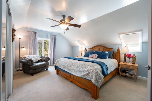 carpeted bedroom featuring ceiling fan and vaulted ceiling