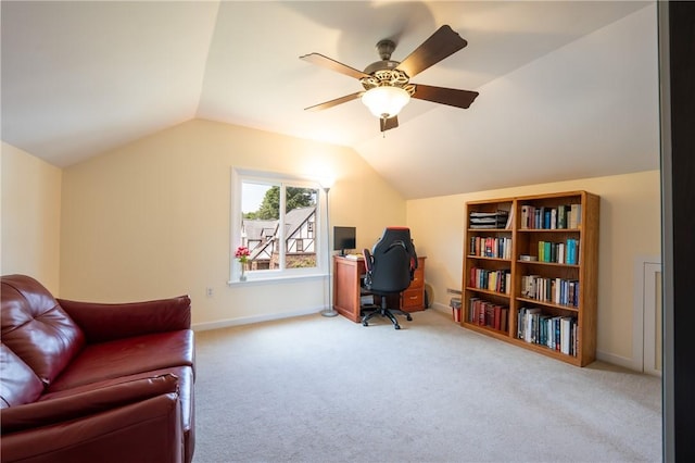 carpeted office space featuring vaulted ceiling and ceiling fan