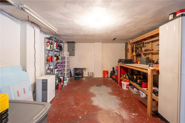 basement with electric panel and a workshop area