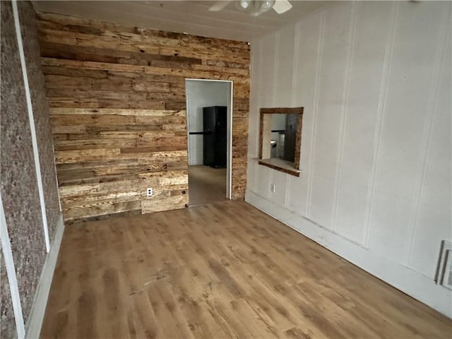 empty room featuring hardwood / wood-style flooring and ceiling fan