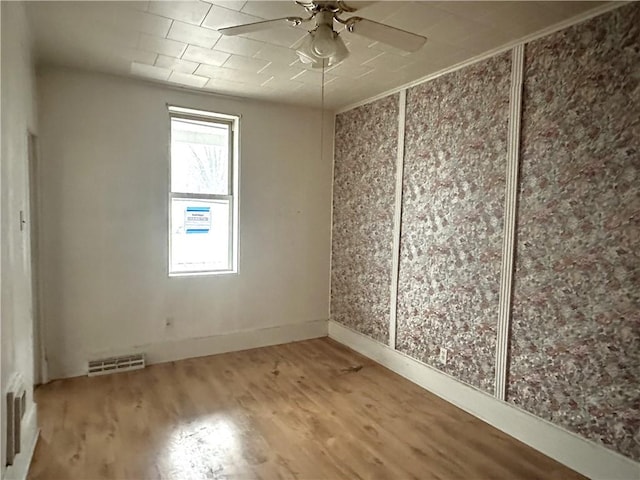 unfurnished room with ceiling fan and hardwood / wood-style floors