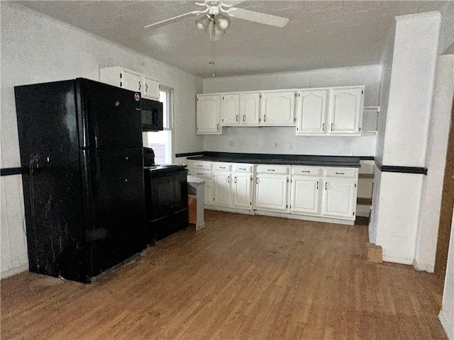 kitchen with white cabinetry, hardwood / wood-style floors, ceiling fan, and black appliances