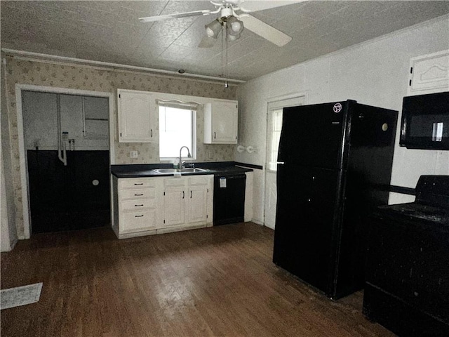 kitchen featuring sink, ceiling fan, white cabinetry, black appliances, and dark hardwood / wood-style flooring