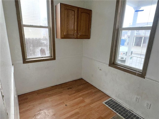 spare room with light hardwood / wood-style flooring