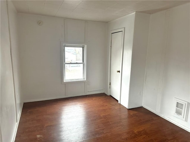 empty room with dark wood-type flooring