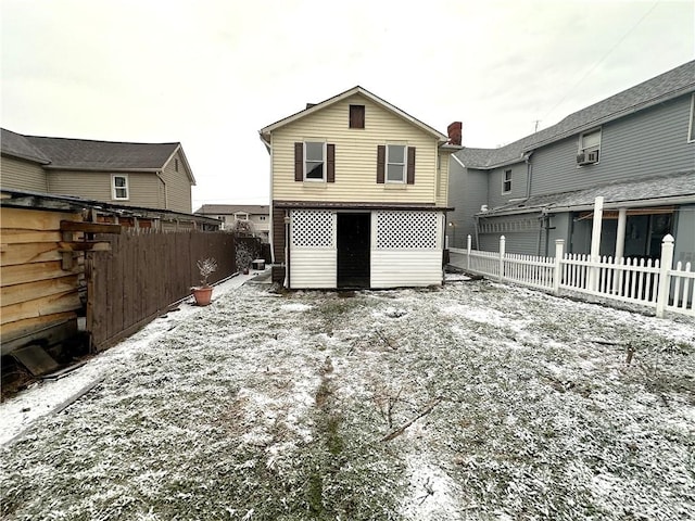 view of snow covered back of property