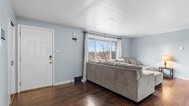 living room with dark hardwood / wood-style flooring