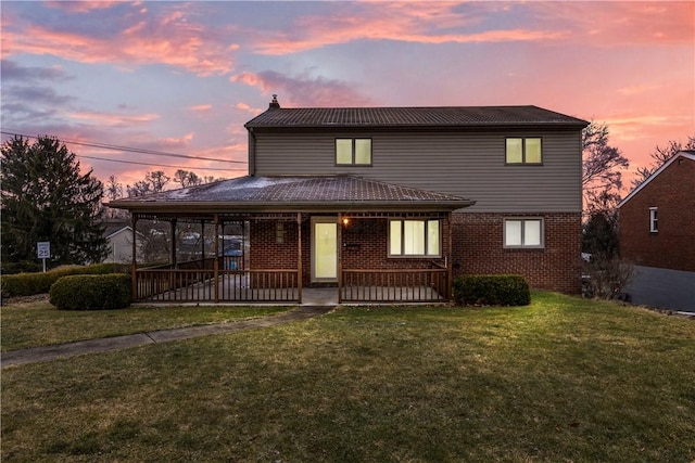 view of front of home featuring a yard and covered porch