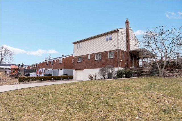 view of side of home featuring a garage and a lawn