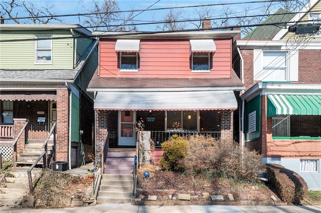 townhome / multi-family property featuring a porch