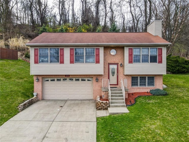 raised ranch with a garage and a front lawn