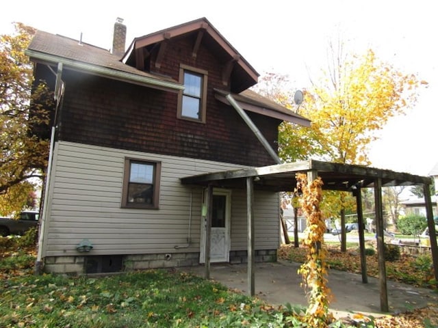 rear view of property with a carport