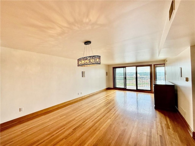 unfurnished living room featuring light wood-style flooring and baseboards