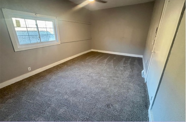 unfurnished bedroom with dark carpet