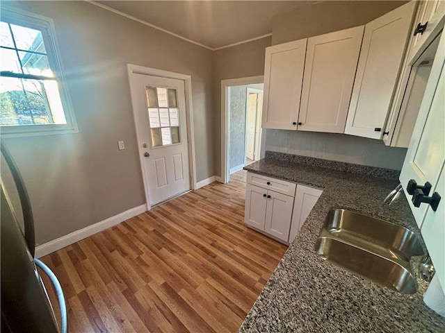 30 1st St, Leetsdale, PA 15056 - kitchen featuring a sink, white cabinets, light wood-style floors, and crown molding