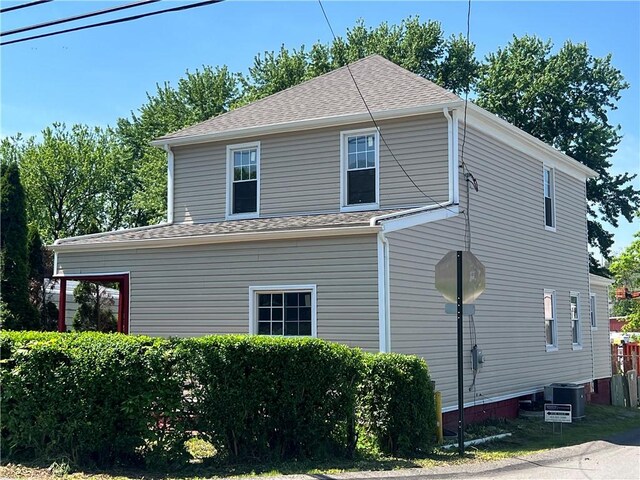 30 1st St, Leetsdale, PA 15056 - view of home's exterior featuring central AC unit and roof with shingles