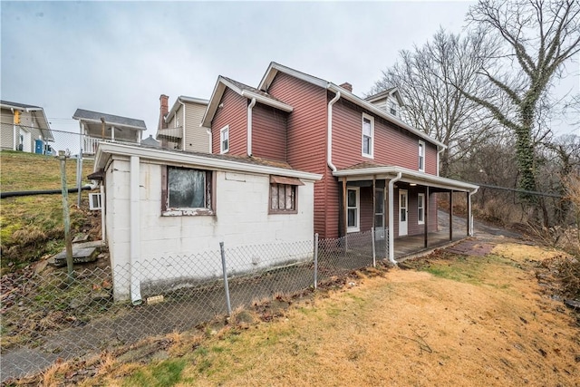 view of side of property with covered porch