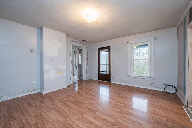 interior space with light hardwood / wood-style floors and a textured ceiling