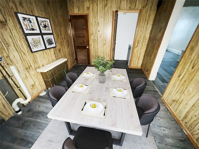 dining room featuring wooden walls