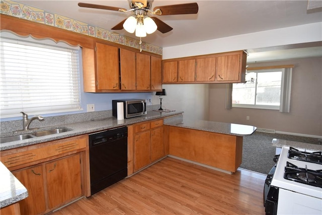 kitchen featuring sink, range with gas cooktop, light wood-type flooring, black dishwasher, and ceiling fan