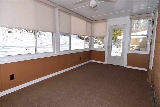 unfurnished sunroom with ceiling fan