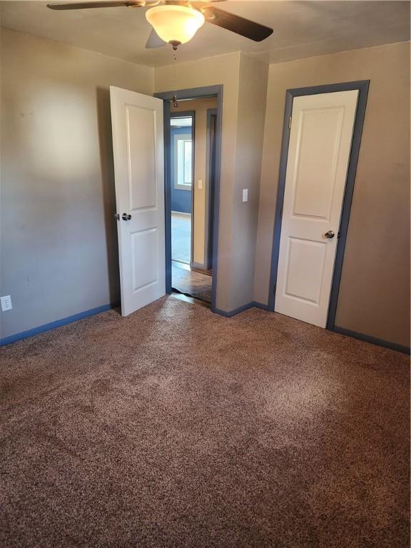 unfurnished bedroom with carpet floors and ceiling fan