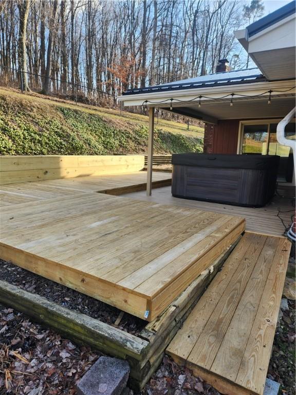 wooden terrace with a hot tub