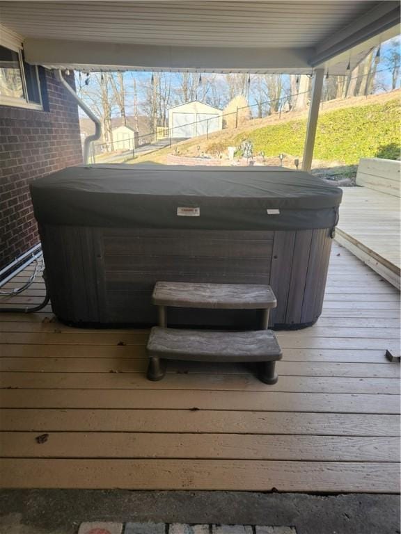 wooden deck featuring a hot tub