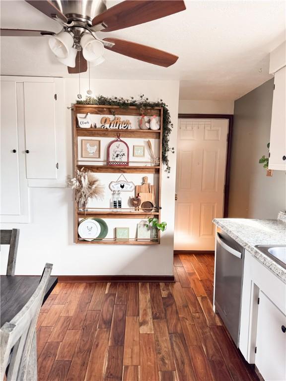 interior space with dishwasher, dark hardwood / wood-style floors, white cabinets, and ceiling fan