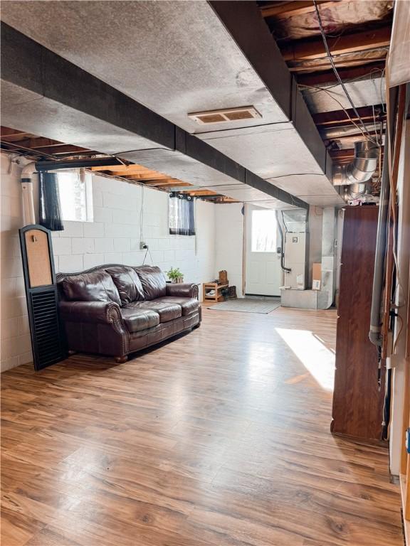 living room with heating unit and hardwood / wood-style flooring