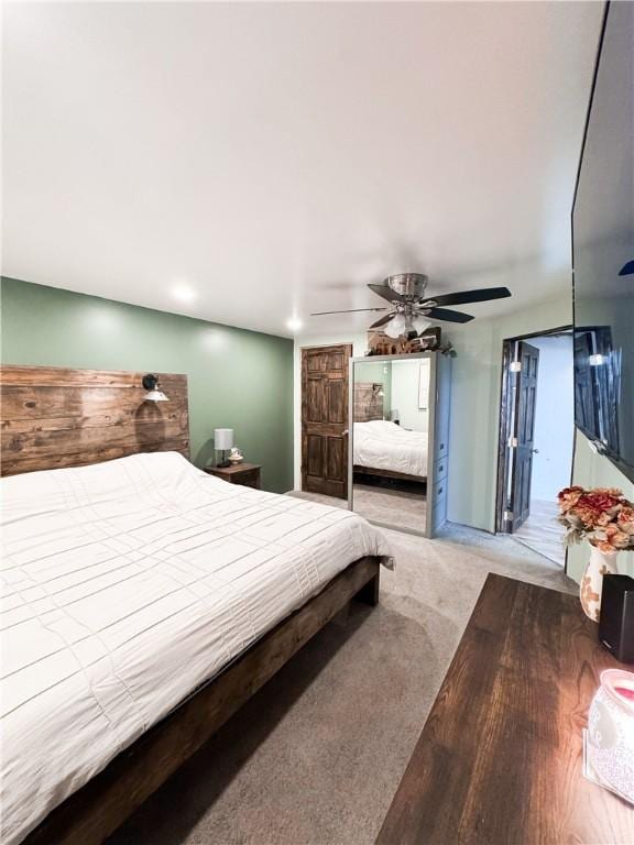 bedroom featuring light carpet and ceiling fan